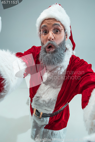 Image of Funny guy in christmas hat. New Year Holiday. Christmas, x-mas, winter, gifts concept.