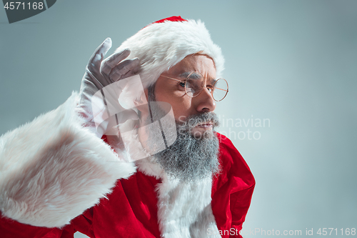 Image of Funny guy in christmas hat. New Year Holiday. Christmas, x-mas, winter, gifts concept.