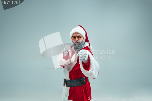 Image of Funny guy in christmas hat. New Year Holiday. Christmas, x-mas, winter, gifts concept.