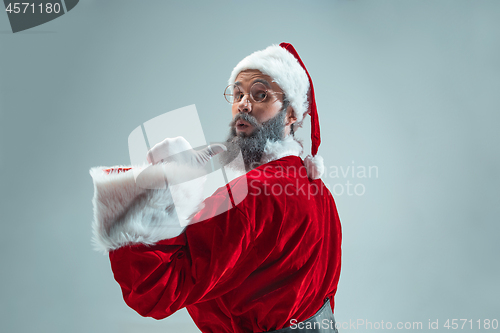 Image of Funny guy in christmas hat. New Year Holiday. Christmas, x-mas, winter, gifts concept.