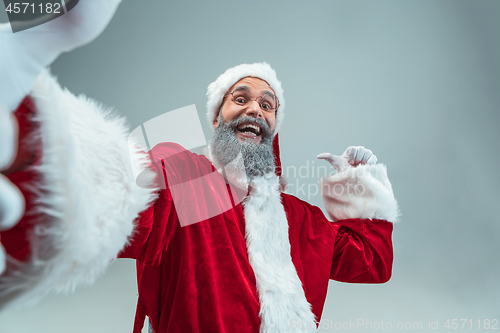 Image of Funny guy in christmas hat. New Year Holiday. Christmas, x-mas, winter, gifts concept.