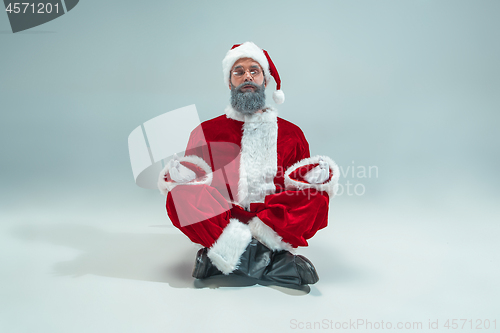 Image of Funny guy in christmas hat. New Year Holiday. Christmas, x-mas, winter, gifts concept.