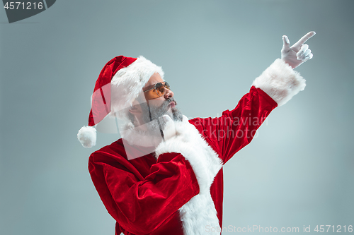 Image of Funny guy in christmas hat. New Year Holiday. Christmas, x-mas, winter, gifts concept.