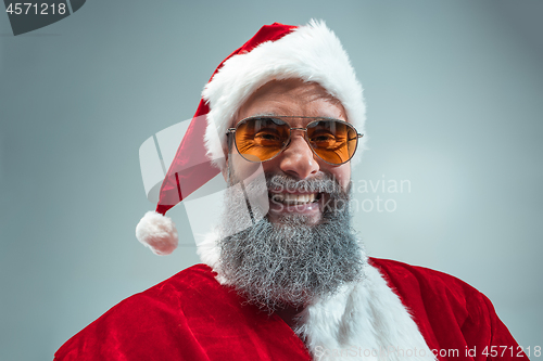 Image of Funny guy in christmas hat. New Year Holiday. Christmas, x-mas, winter, gifts concept.