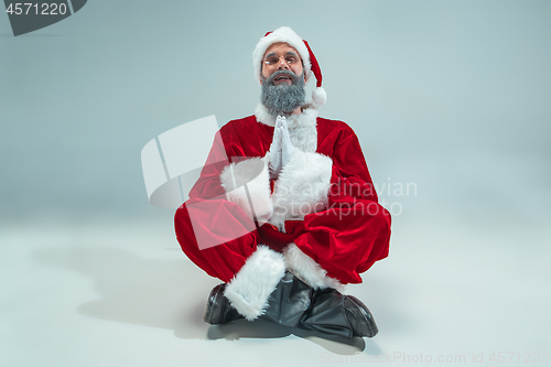 Image of Funny guy in christmas hat. New Year Holiday. Christmas, x-mas, winter, gifts concept.