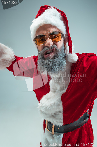 Image of Funny guy in christmas hat. New Year Holiday. Christmas, x-mas, winter, gifts concept.