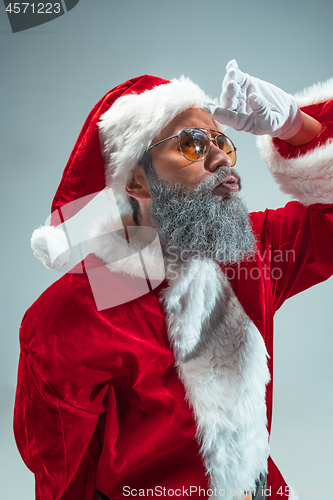 Image of Funny guy in christmas hat. New Year Holiday. Christmas, x-mas, winter, gifts concept.