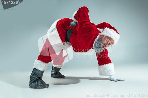 Image of Funny guy in christmas hat. New Year Holiday. Christmas, x-mas, winter, gifts concept.