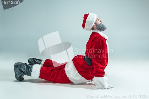 Image of Funny guy in christmas hat. New Year Holiday. Christmas, x-mas, winter, gifts concept.