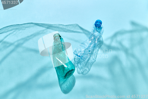 Image of Marine waves from shadows of plastic foil with floating bottles.