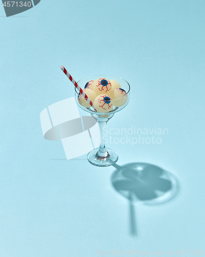 Image of Halloween cocktail with eyeballs in glass.