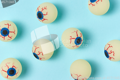 Image of Halloween pattern eyeballs on a pastel blue background.