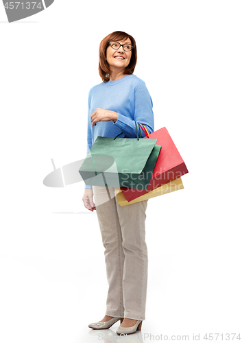 Image of senior woman with shopping bags isolated on white