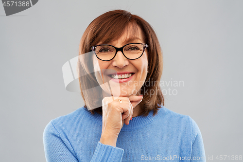 Image of portrait of senior woman in glasses over grey