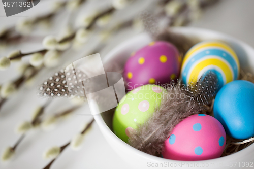 Image of colored easter eggs and pussy willow branches