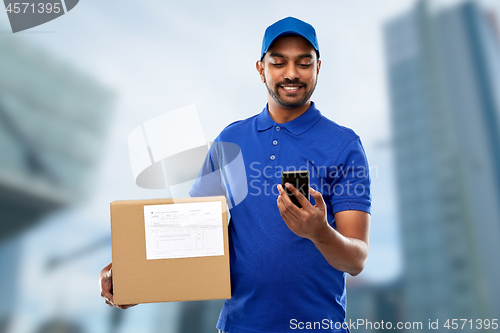 Image of indian delivery man with smartphone and parcel box