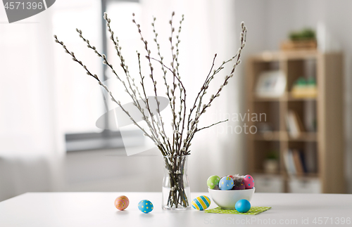 Image of pussy willow branches and colored easter eggs