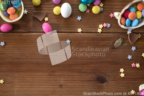 Image of chocolate eggs and candy drops on wooden table