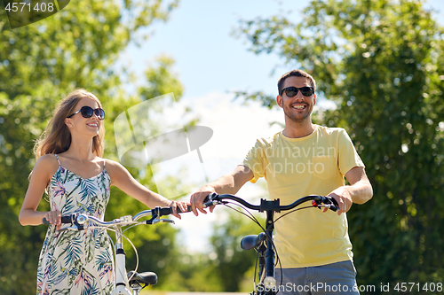 Image of happy couple with bicycles at country
