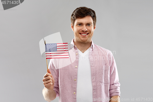 Image of happy man with american flag over grey background