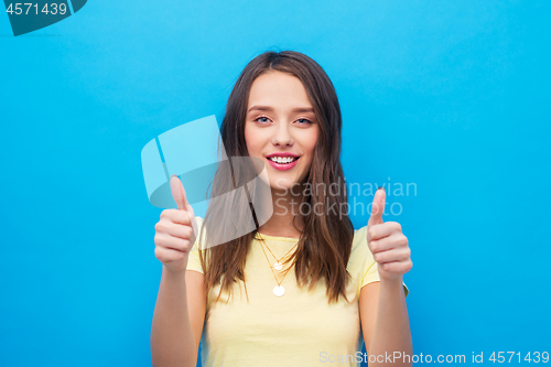 Image of young woman or teenage girl showing thumbs up