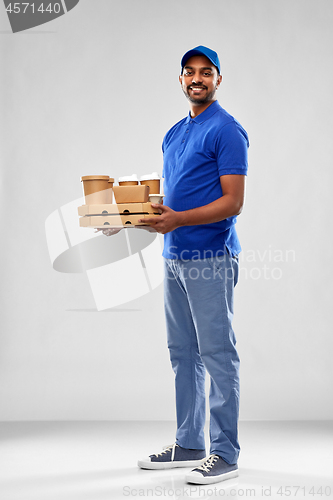 Image of happy indian delivery man with food and drinks