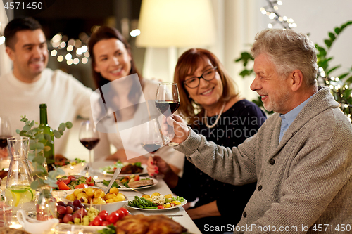 Image of happy family having dinner party at home