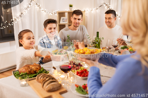 Image of happy family having dinner party at home