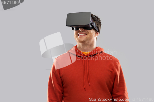 Image of happy man in virtual reality headset or vr glasses