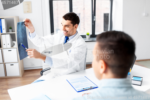 Image of doctor showing x-ray to patient at hospital