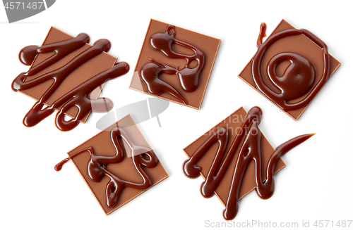Image of chocolate squares decorated with chocolate sauce