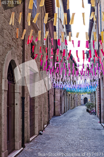 Image of Colorful paper flags over italian street.