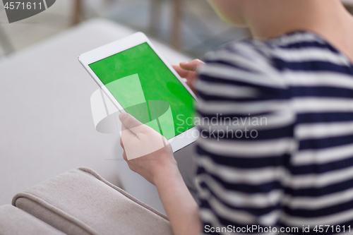 Image of woman on sofa using tablet computer