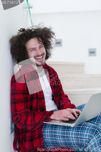 Image of freelancer in bathrobe working from home