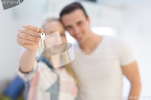 Image of couple showing a keys of their new house