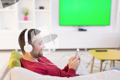 Image of man enjoying music through headphones