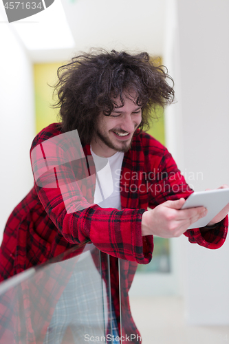Image of young freelancer using tablet computer