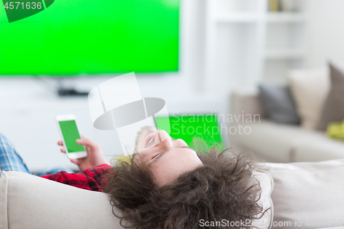 Image of young man in bathrobe enjoying free time