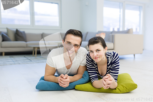 Image of couple lying on the floor at home