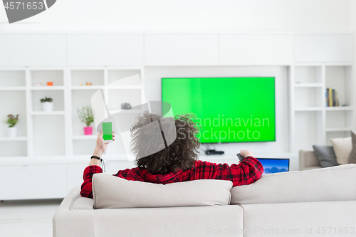 Image of young man in bathrobe enjoying free time