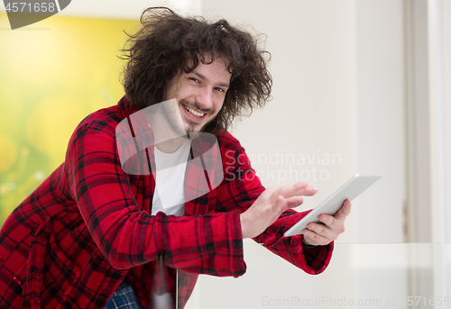 Image of young freelancer using tablet computer