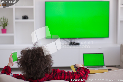 Image of young man in bathrobe enjoying free time