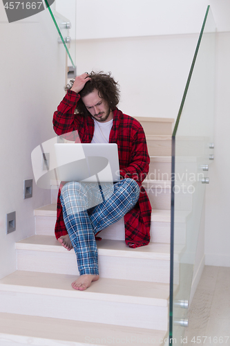 Image of freelancer in bathrobe working from home