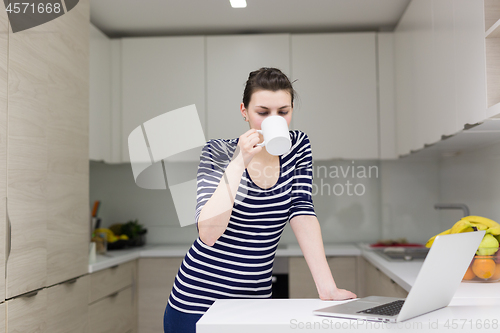 Image of woman drinking coffee enjoying relaxing lifestyle