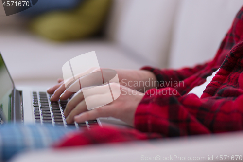 Image of man freelancer in bathrobe working from home