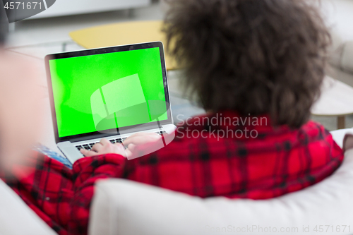 Image of man freelancer in bathrobe working from home