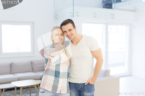 Image of couple showing a keys of their new house