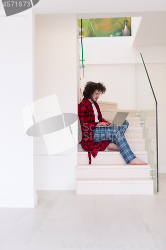 Image of freelancer in bathrobe working from home