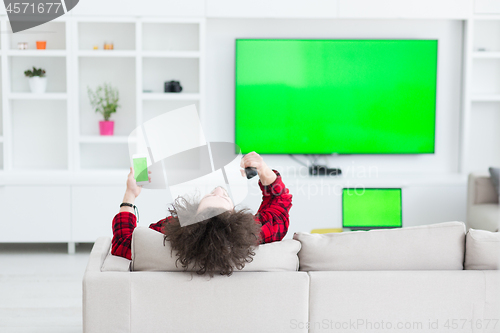 Image of young man in bathrobe enjoying free time