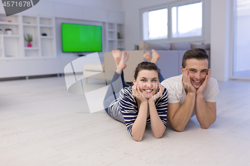 Image of couple lying on the floor at home
